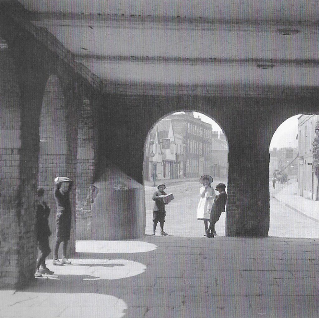 One of George Ward’s photographs shows children playing near the Market Hall. 50 years of the Amersham Society, 2006